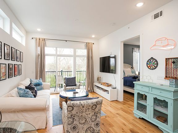 Cozy living space for relaxing and enjoying downtime. Large Smart TV, and features a balcony for morning coffee.