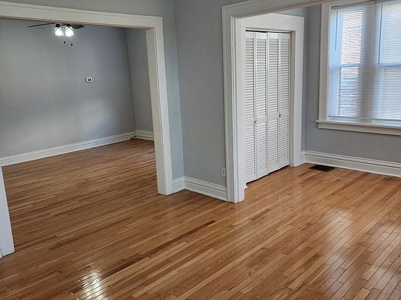Another view of front room with bonus side room with additional hanging closet storage can be used as a small office space.
