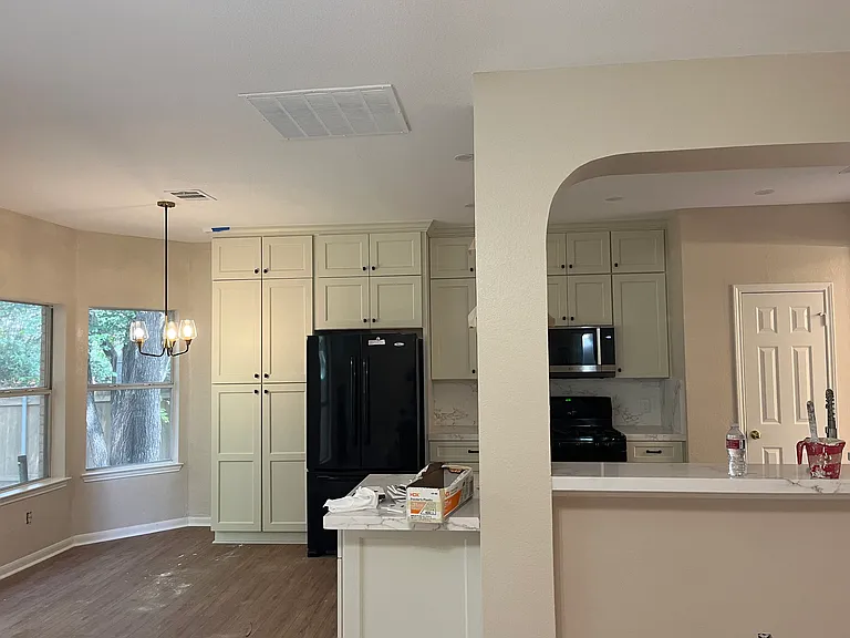 View of Kitchen and Breakfast Nook from Living Room - archways add charm and character to the space.