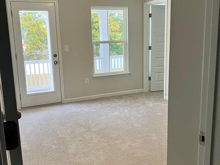 Upstairs bedroom with balcony. There are a total of 4 bedrooms upstairs.