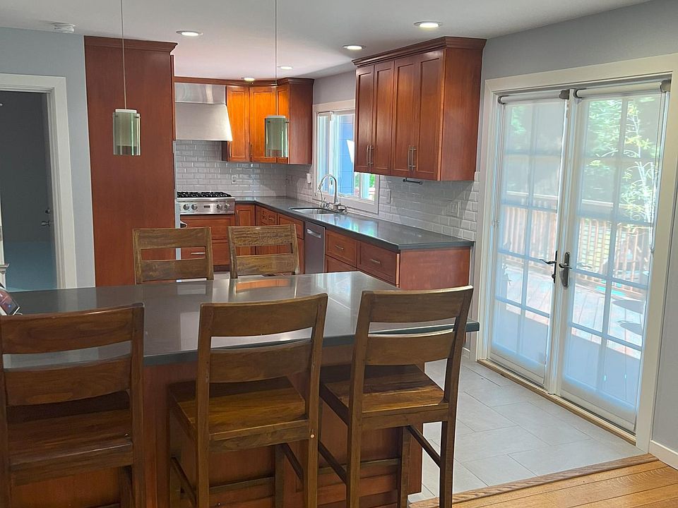 Peninsula, kitchen, and French doors onto deck
