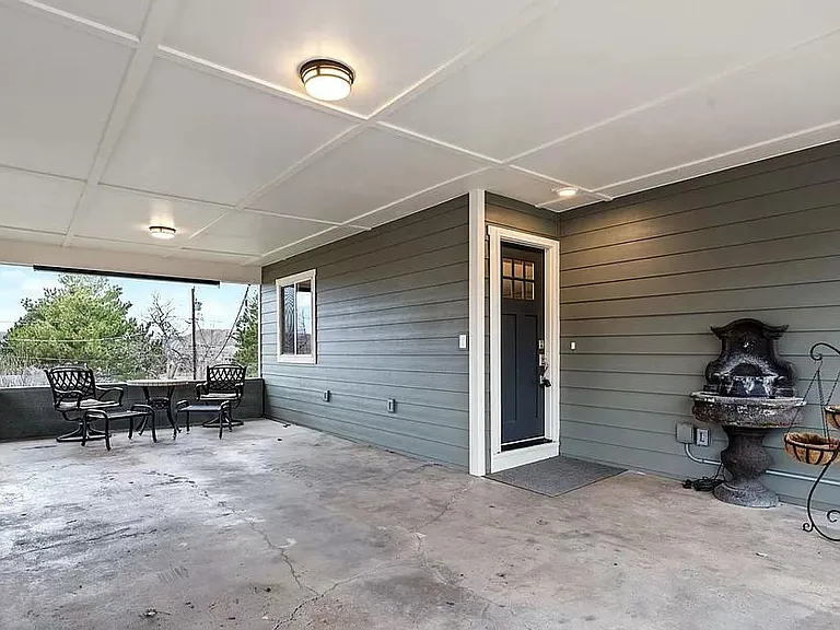Carport (with planter boxes on left), used as a patio area by previous renters). There are 2 storage units in the backyard for sports equipment, bikes, Christmas decorations, gardening equipment, extra fridge or freezer, etc...