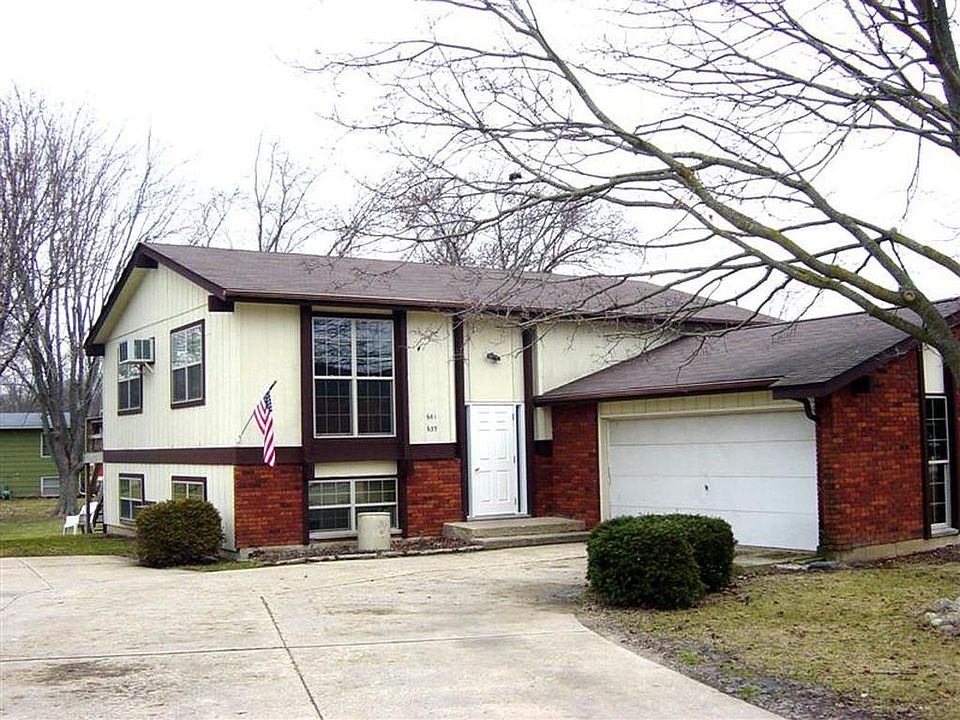 Front with view of attached garage.