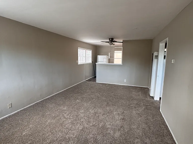 View of the front door entrance into the living room & dining area