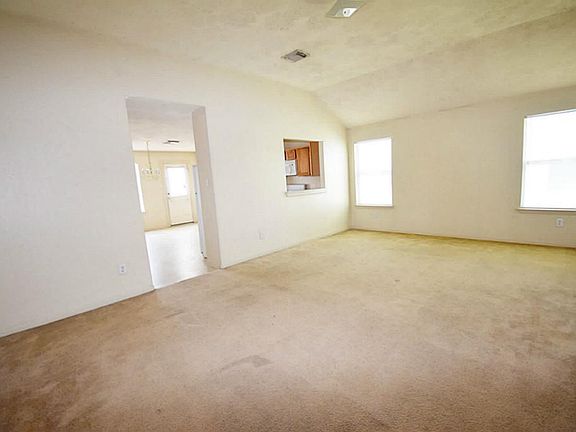 Sizable living room with carpet floor.