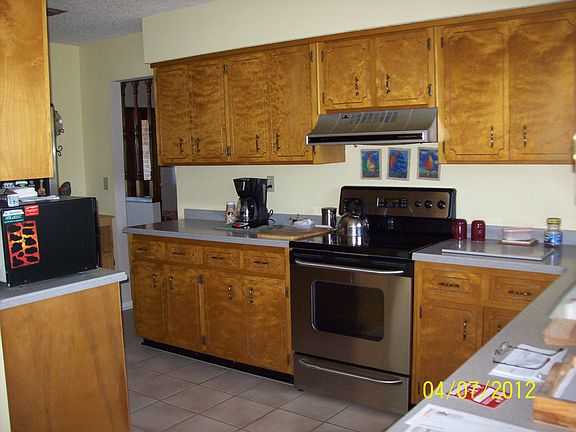 Spacious kitchen with stainless steel appliances.