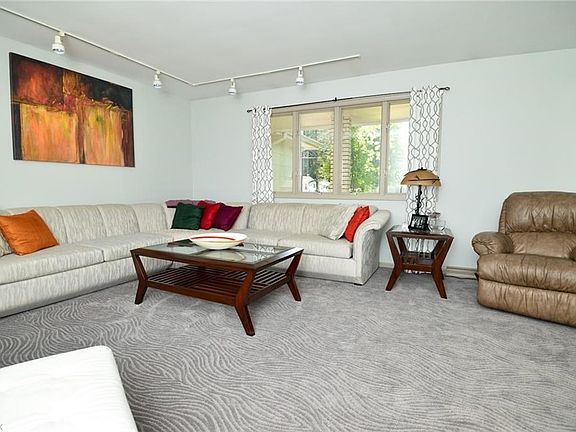 Entertainment throughout the house includes Formal Living Room off Foyer. Hardwood Flooring underneath carpet.