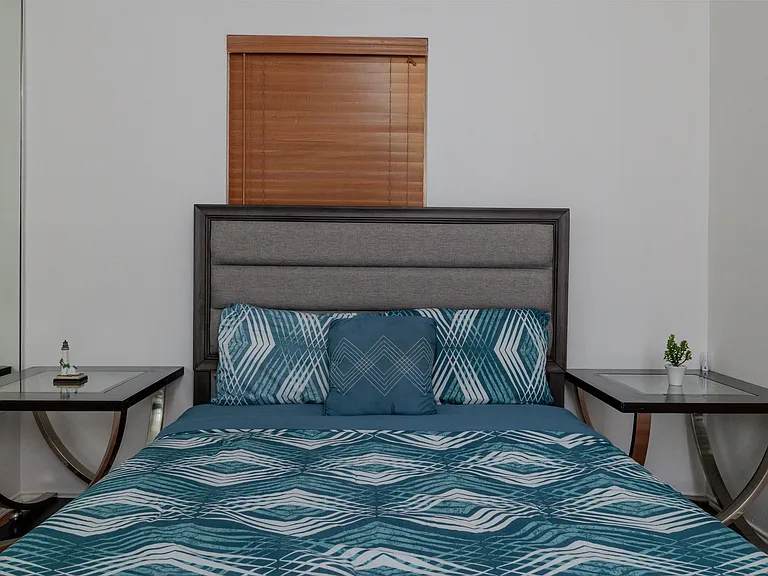 Bedroom #2 with queen size bed and mirrored wall.