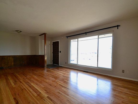 Living room with huge picture window and hardwood floors