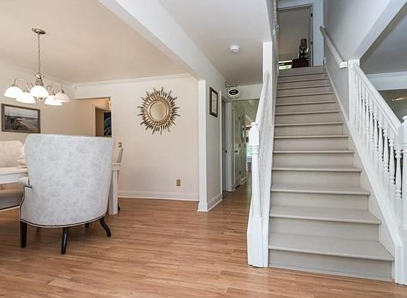 View from the front door, the dinning room is to the left and the hardwood stairs lead to the master suite and 3 additional bedrooms. The hallway to the left leads to the main floor laundry room and the kitchen, the hallway to the right leads to the powde