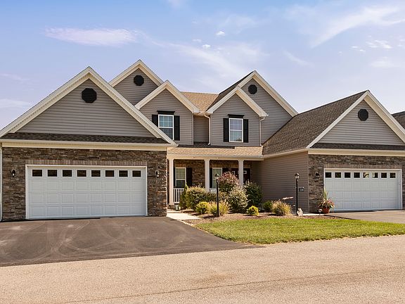 The Glennfield carriage home at Harvest Glen - two units building - two story home with front porch