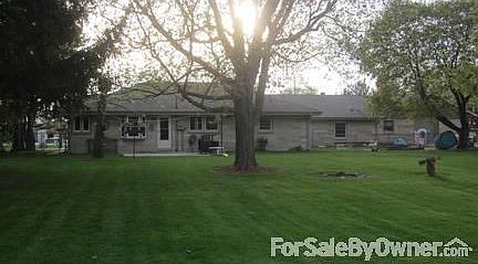 Back yard : Fire pit, rock garden, perennials, Fenced yard with 4 gates. Tall pines.