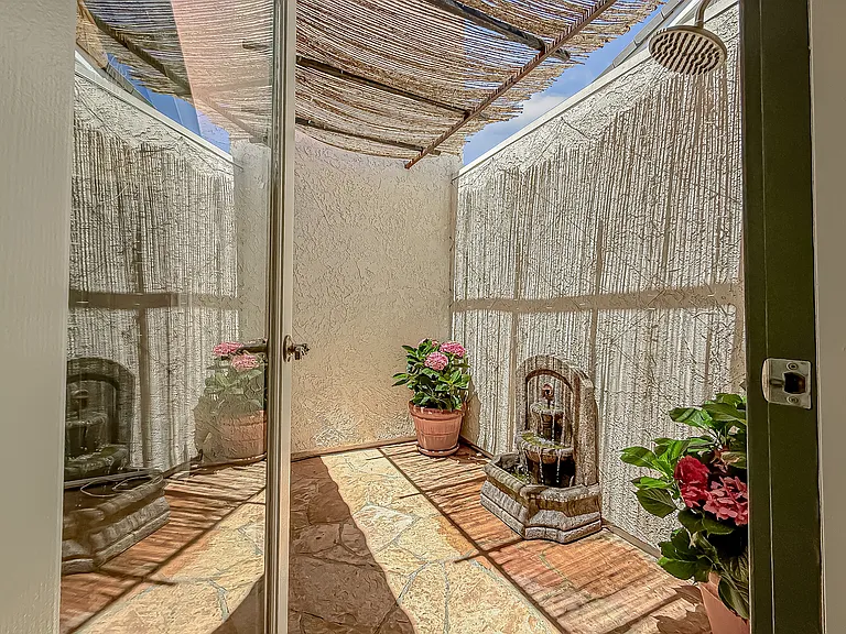 Atrium and outdoor shower opens from primary bathroom