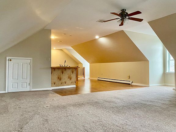 Living Room with Ceiling Fan and Storage Closet