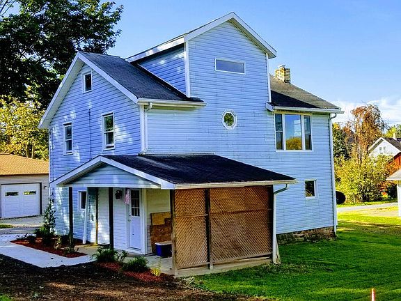 Rear of house, showing landscaping, entrance door and walkway, and living room window (upstairs), all new for fall 2018.