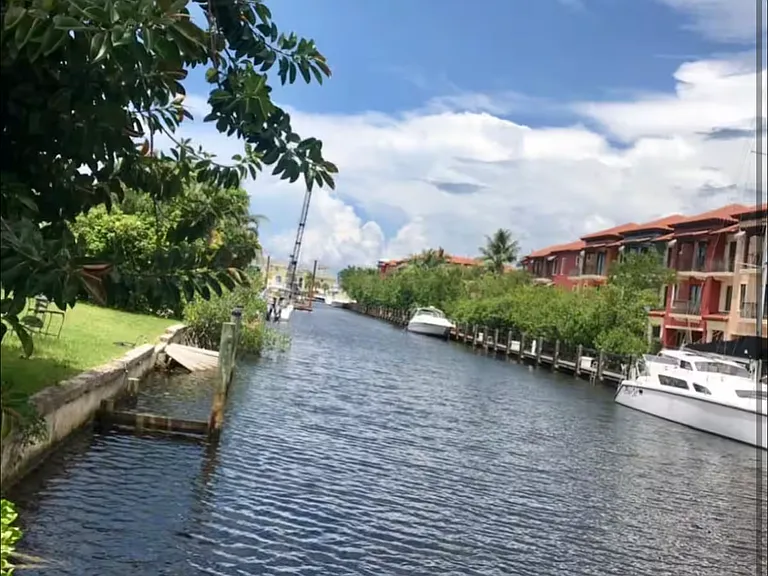 View down the canal. However, Naples Bay resort has now been painted white. That is what you were looking at across the canal.