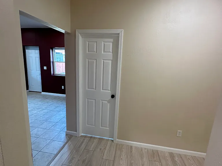 Facing bedroom door and kitchen to the left living room to the right.