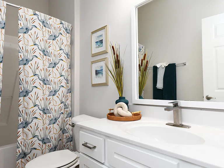 Bright bathroom with quartz counters and bathtub