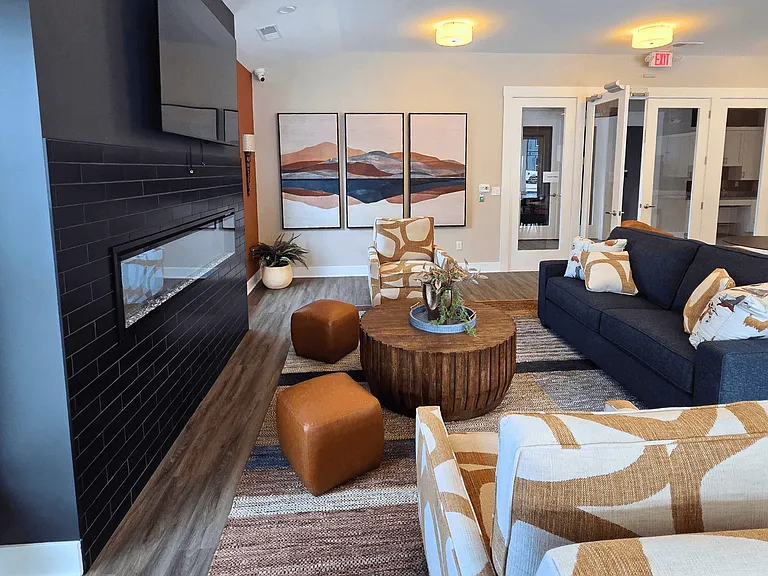 Clubhouse lounge area with seating, television, and fireplace at Greenwood Commons in Delaware, OH.