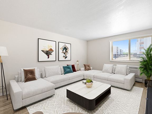 Spacious lounge with cozy sectional and bright window