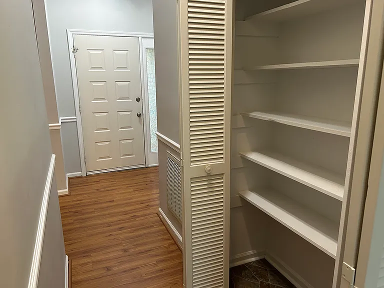 Entry hall looking toward front door. Pantry area to right.