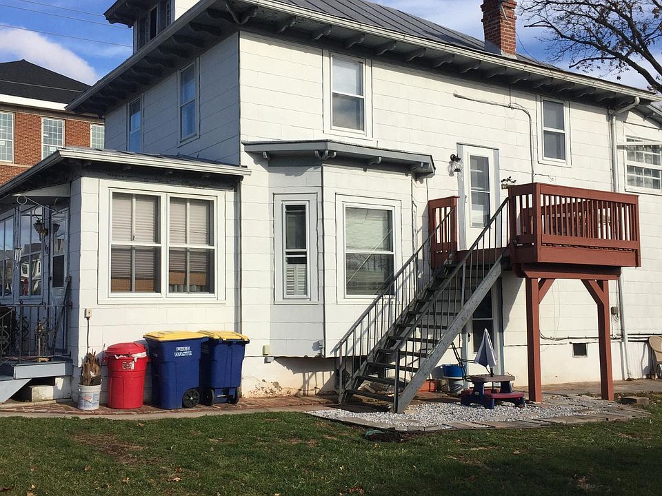 Outside stairs to small deck and entry door as well as basement door (under deck)