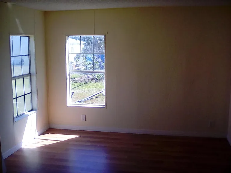 Master Bedroom with corner windows and new wood flooring