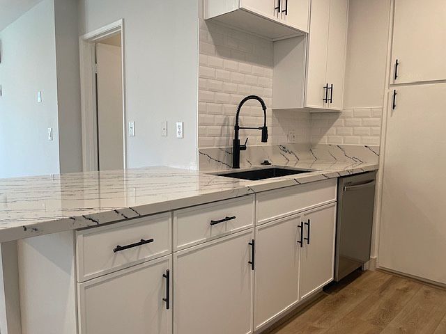 Gorgeous new kitchen with dark hardware, quartz counters, contemporary shaker cabinets, brand new stainless appliances