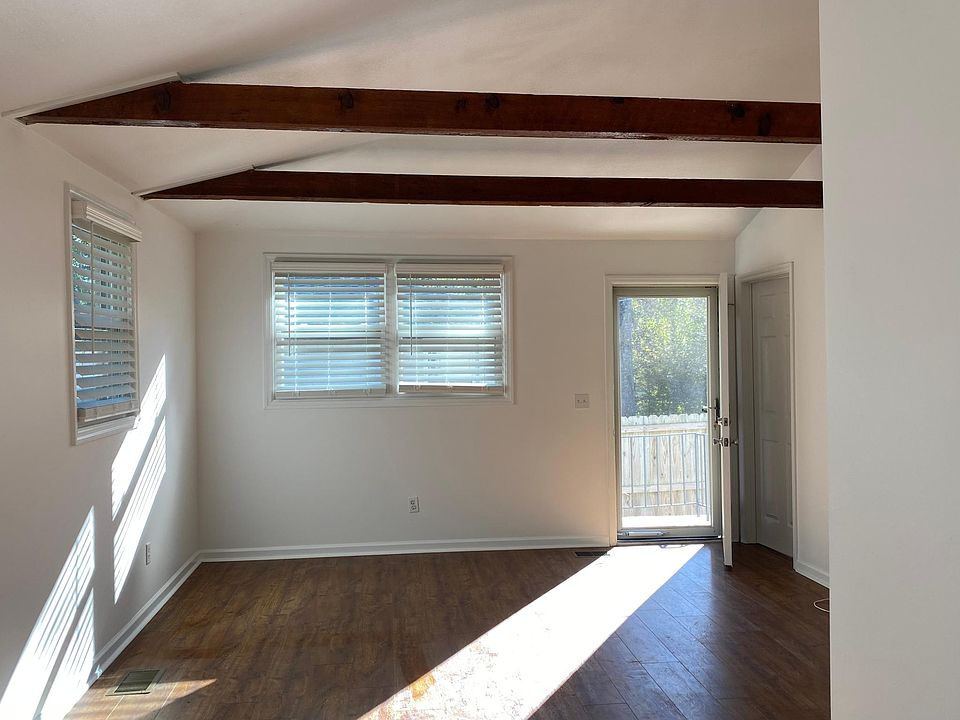 Living room with hardwood floors throughout entire unit.