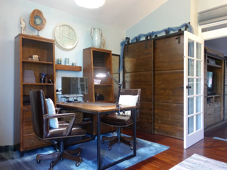 Office den with a closet space that can double as a bookcase.