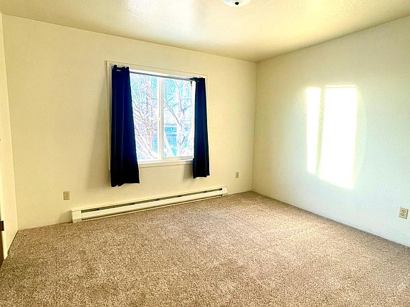 Bedroom has large, bright window and huge walk-in closet.
