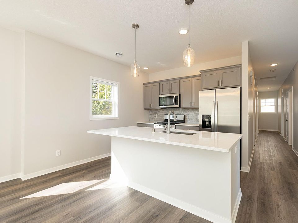 Open kitchen and living room with tall ceilings.