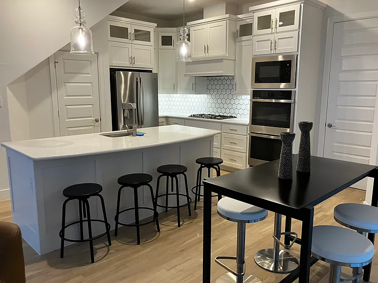 kitchen view: note glass-faced upper cabinets; clean, modern lines