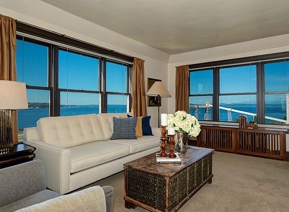 The spacious living area features refinished hardwood floors & c