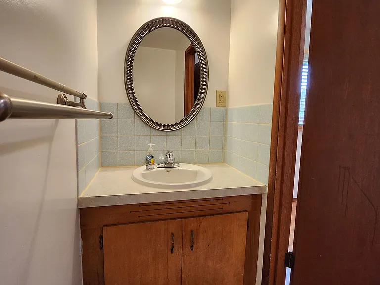 Primary Suite, attached bathroom with cute vintage touches.