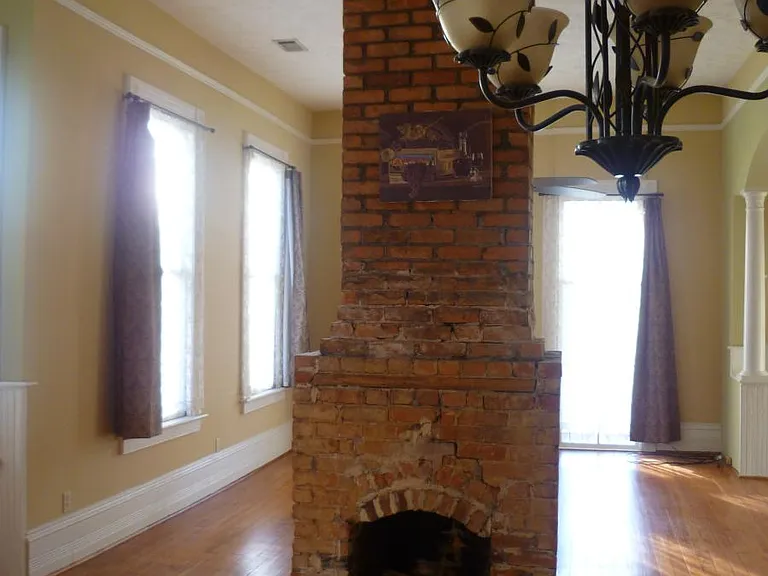Exposed brick, free-standing chimney, with fireplaces on both sides!