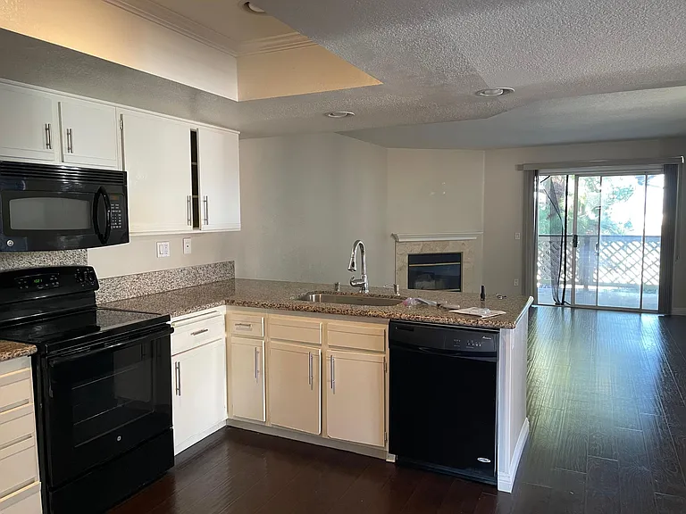 Kitchen with matching color microwave, stove, and dishwasher.