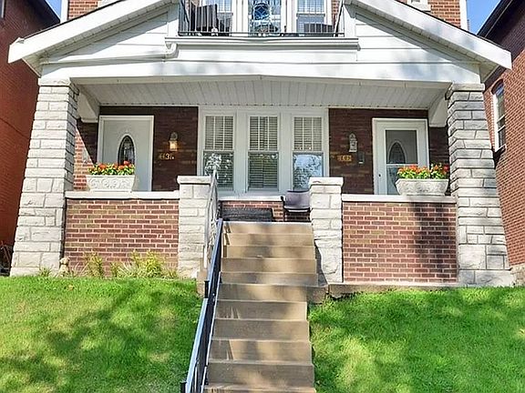 Front of building, well-kept & all-brick w/ park views