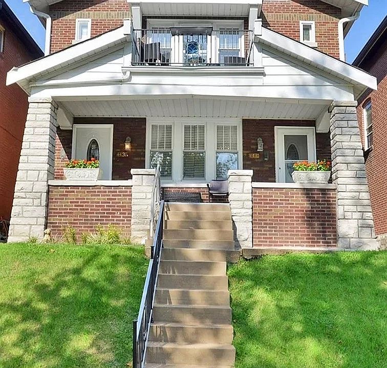 Front of building, well-kept & all-brick w/ park views