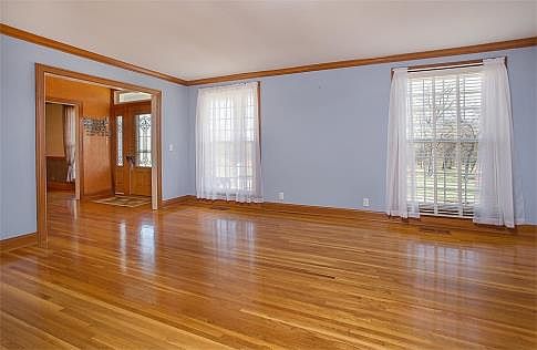 Living room with gleaming hardwoods.