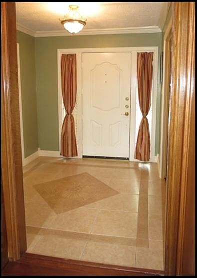 Entry with decorative tile flooring.
