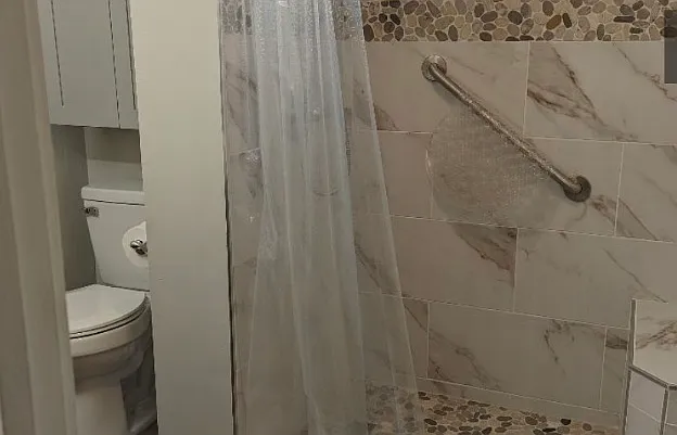 Custom Shower with built in seat. Extra storage above toilet.