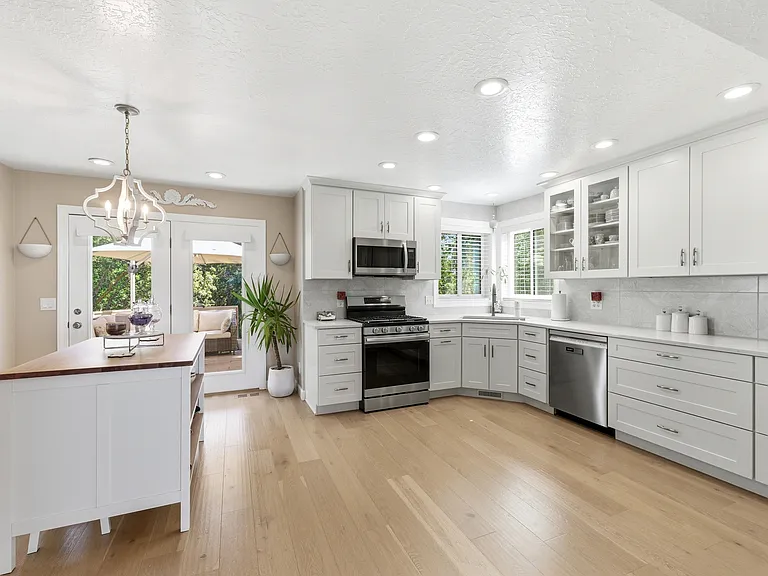 Modern kitchen with quartz countertops, ample cabinetry with lower drawers, and generous prep space.