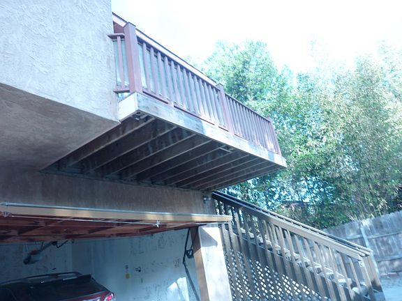 PATIO , GARAGE, STAIRCASE TO UNIT, PATIO LEADING FROM LIVING ROOM.