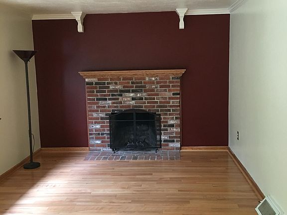 Living room with hardwood floors?wood burning fireplace and central air.