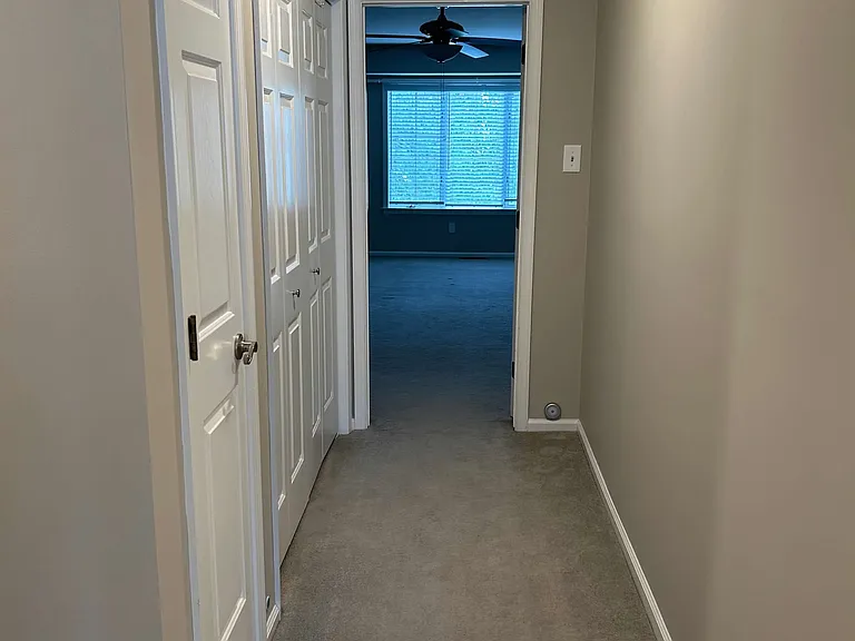 Upstairs hallway, linen closet, and laundry area on left.
