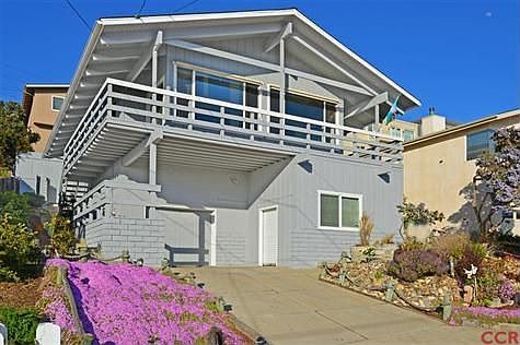 Workshop to right with roll-up door. Both garage and workshop have high ceilings.