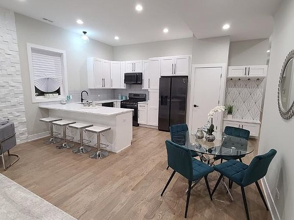 Quartz countertops Black stainless steel Appliances Notice the great number of recess lighting throughout unit.