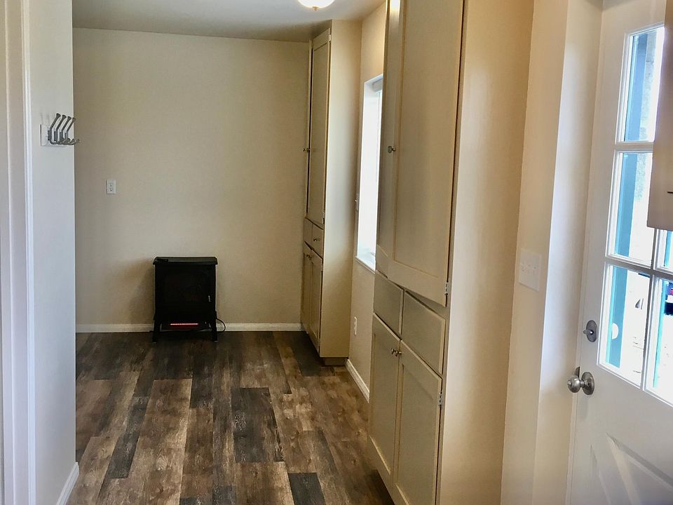 Entry door and hall, and moveable electric fireplace heater.