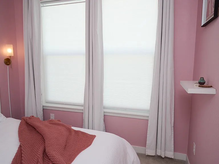 Blinds for privacy and black out curtains for light control.